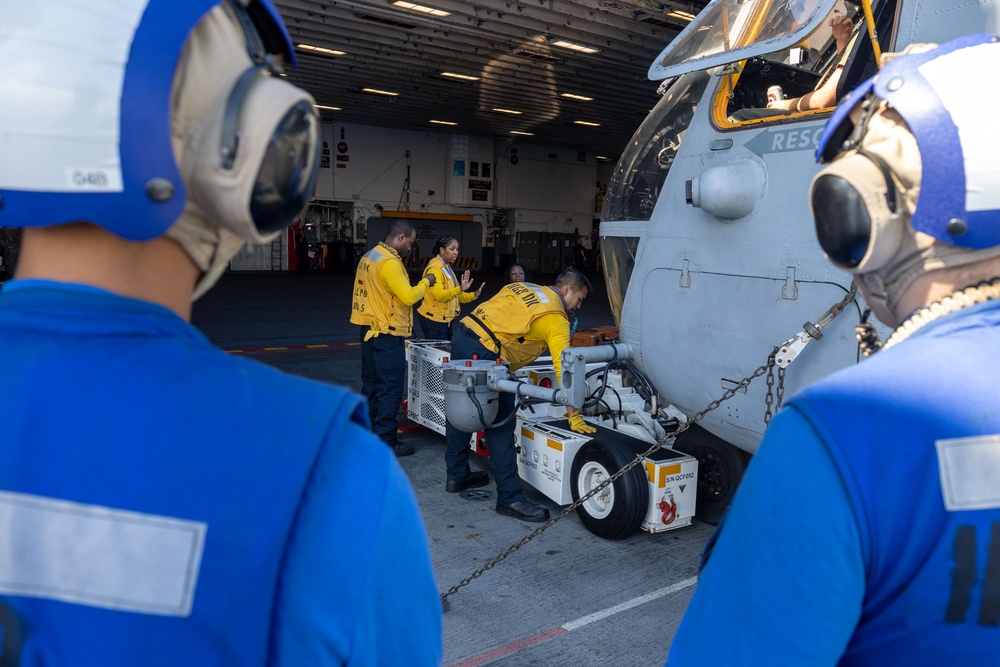 USS Bataan Sailors move an aircraft