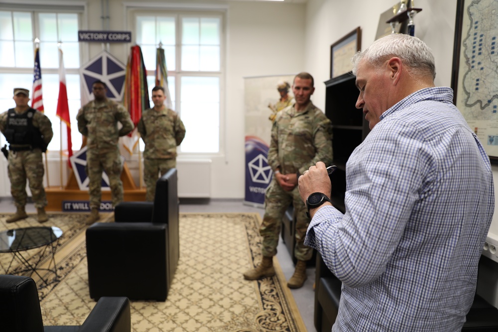 USAREUR-AF Command Sgt. Maj. Jeremiah Inman coins Soldiers at USAG-Poland