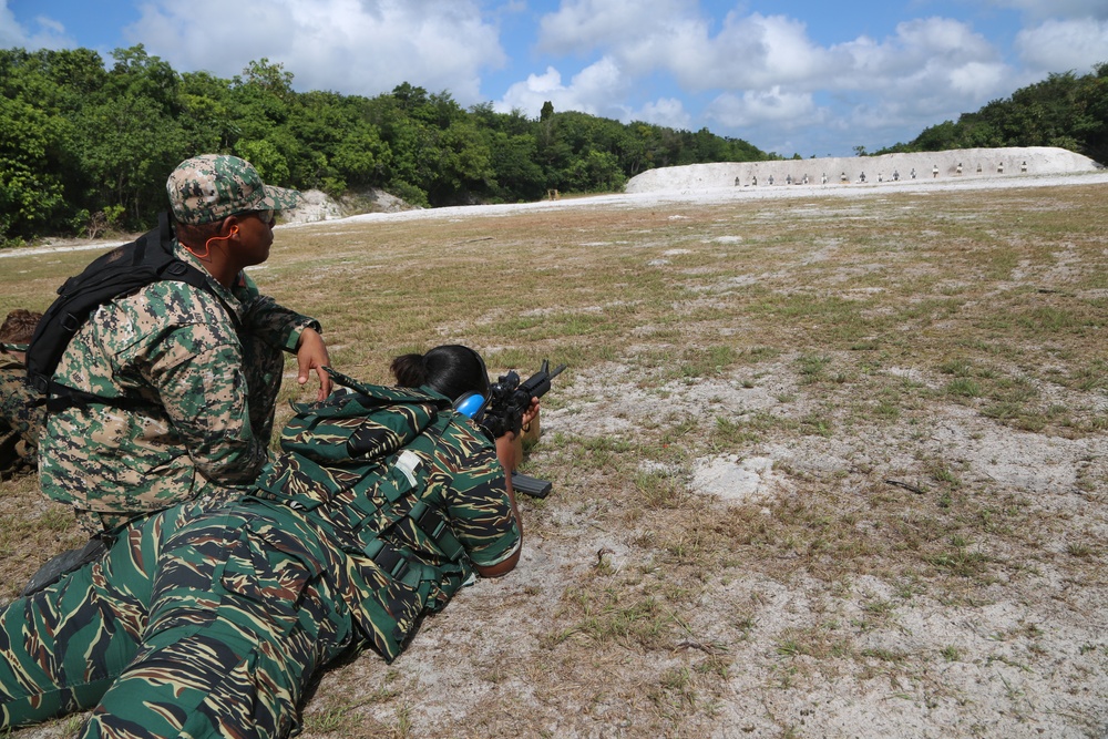 Antigua and Barbuda Merchant Marines assists a Guyana Defence Force Soldier during live-fire exercise