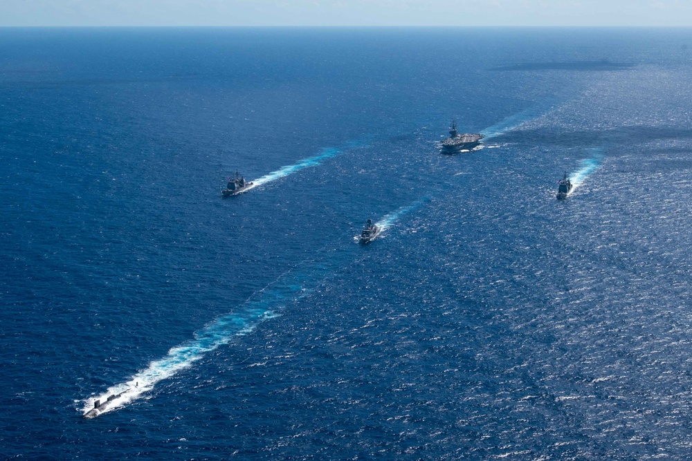 USS Ronald Reagan (CVN 76) sails in formation with HMAS Perth during Talisman Sabre 23