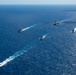 USS Ronald Reagan (CVN 76) sails in formation with HMAS Perth during Talisman Sabre 23