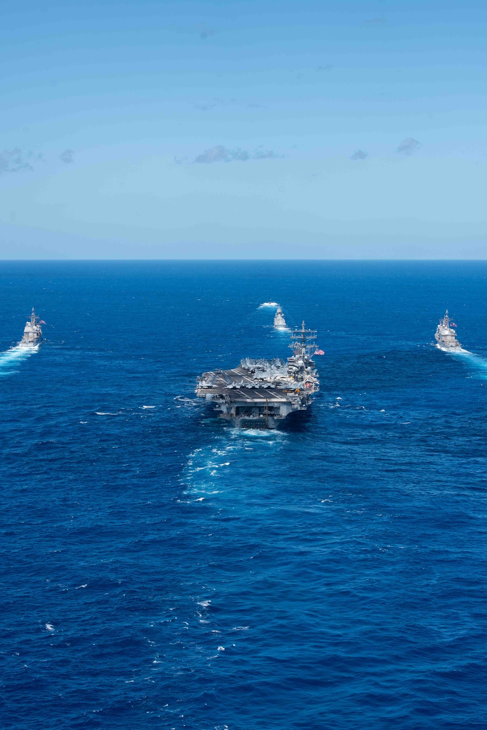 USS Ronald Reagan (CVN 76) sails in formation with HMAS Perth during Talisman Sabre 23