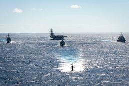 USS Ronald Reagan (CVN 76) sails in formation with HMAS Perth during Talisman Sabre 23