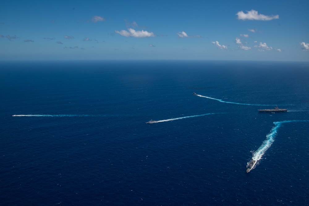 USS Ronald Reagan (CVN 76) sails in formation with HMAS Perth during Talisman Sabre 23