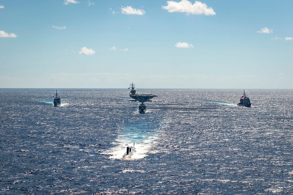 USS Ronald Reagan (CVN 76) sails in formation with HMAS Perth during Talisman Sabre 23