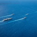 USS Ronald Reagan (CVN 76) sails in formation with HMAS Perth during Talisman Sabre 23