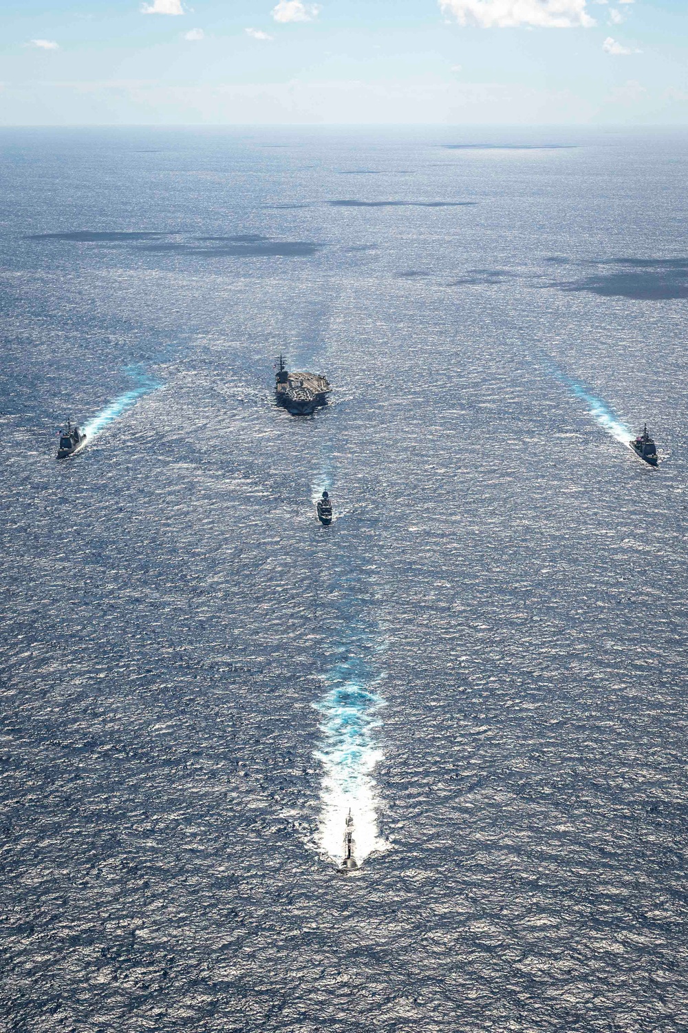 USS Ronald Reagan (CVN 76) sails in formation with HMAS Perth during Talisman Sabre 23