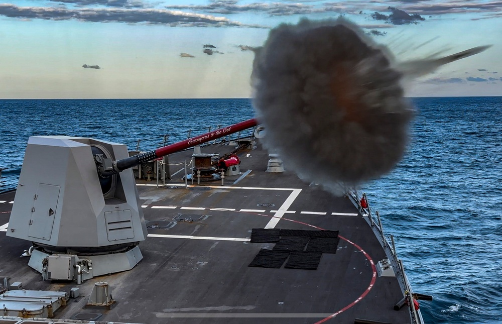 USS Rafael Peralta (DDG 115) fires a Mark 45 5-inch gun during a live fire exercise