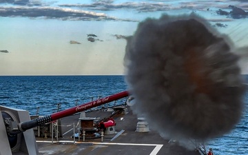 USS Rafael Peralta (DDG 115) fires a Mark 45 5-inch gun during a live fire exercise