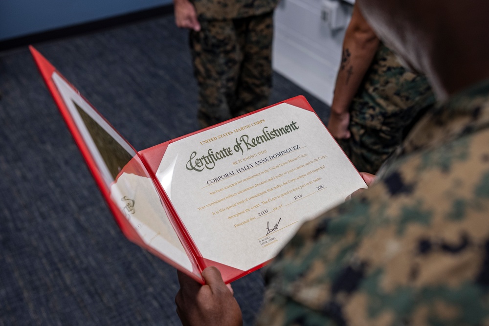 Assistant Commandant of the Marine Corps Gen. Eric M. Smith reenlists Cpl. Haley Dominguez