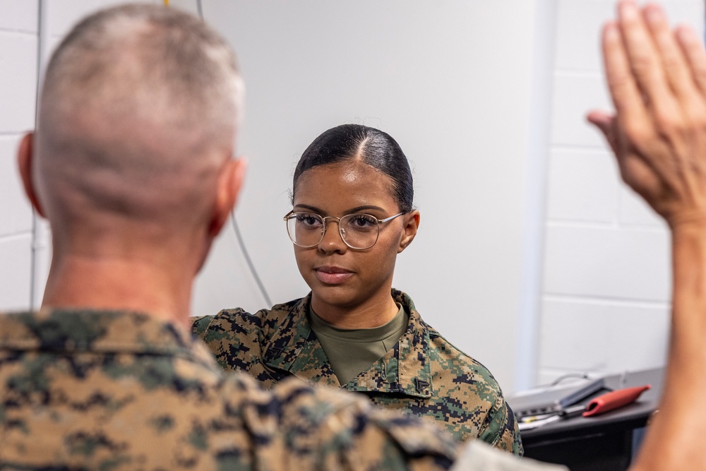 Assistant Commandant of the Marine Corps Gen. Eric M. Smith reenlists Cpl. Haley Dominguez