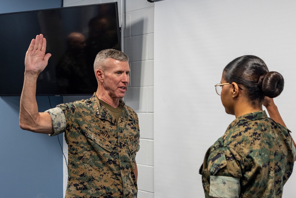 Assistant Commandant of the Marine Corps Gen. Eric M. Smith reenlists Cpl. Haley Dominguez