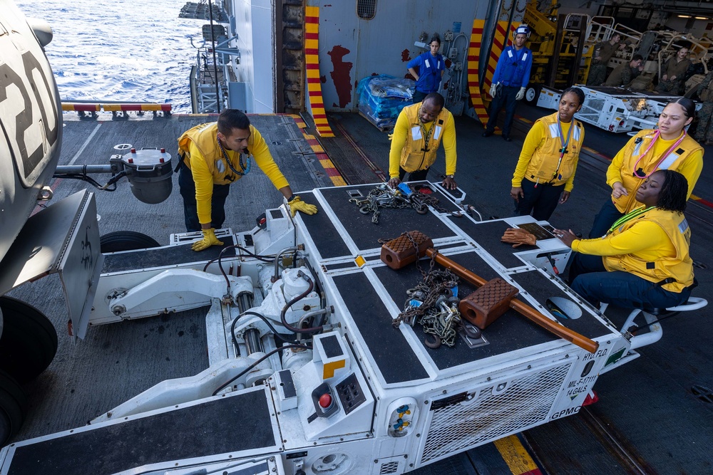 USS Bataan Sailors move an aircraft