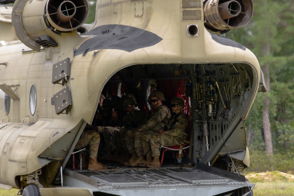 Soldiers with the 78th Training Division secure themselves on a Boeing CH-47 Chinook for boarding operation training as part of warrior exercise (WAREX) 2023.