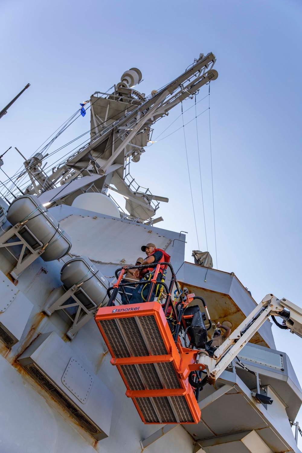 USS Ralph Johnson Sailors conduct paint preservation.