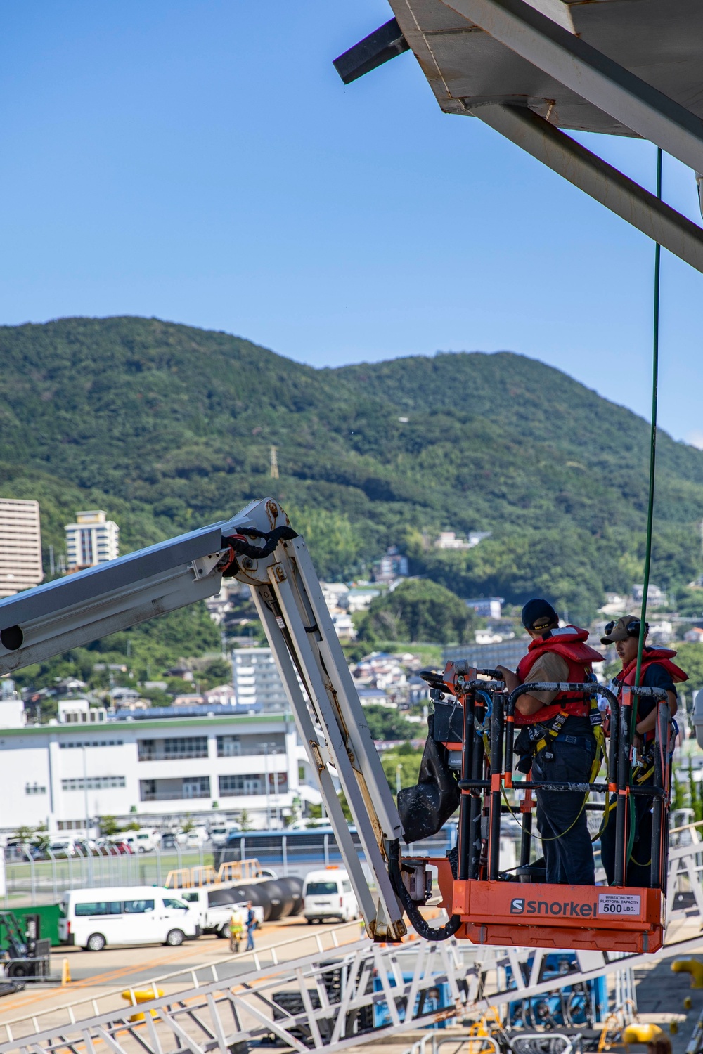 USS Ralph Johnson Sailors conduct paint preservation.