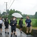 Students walk with a Marine