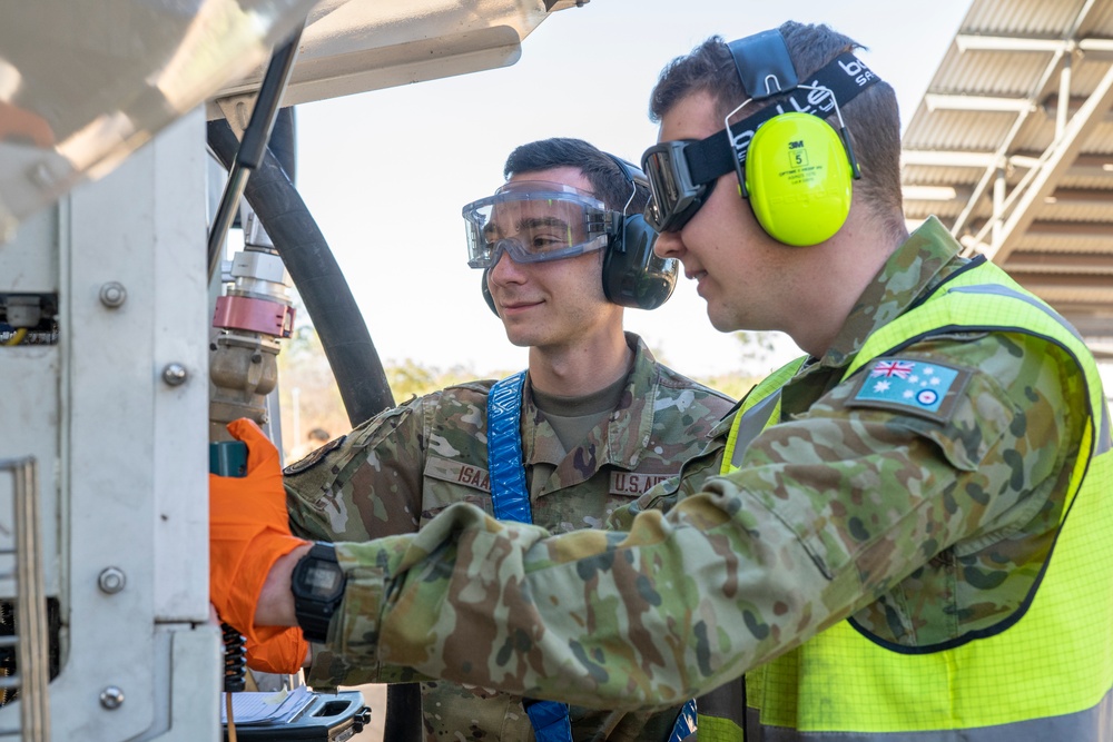 USAF Airmen and RAAF aviator refuel F-22 Raptors