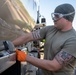 USAF Airmen and RAAF aviator refuel F-22 Raptors