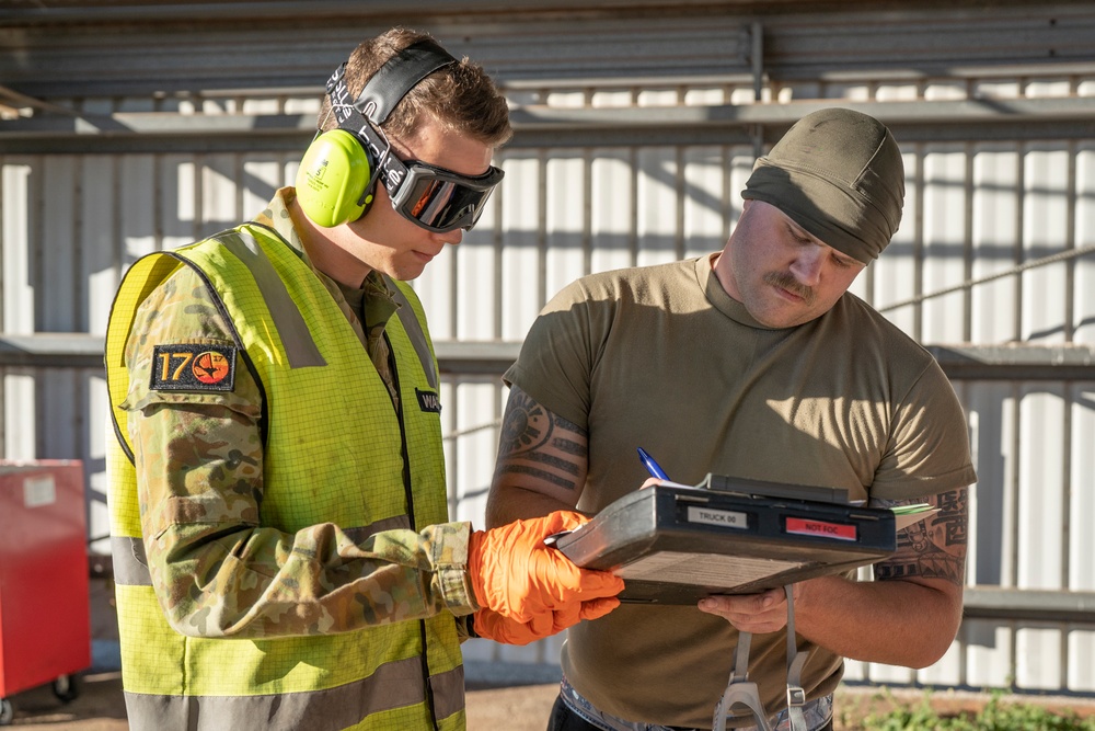 USAF Airmen and RAAF aviator refuel F-22 Raptors