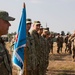 U.S. and international service members stand in formation during award ceremony