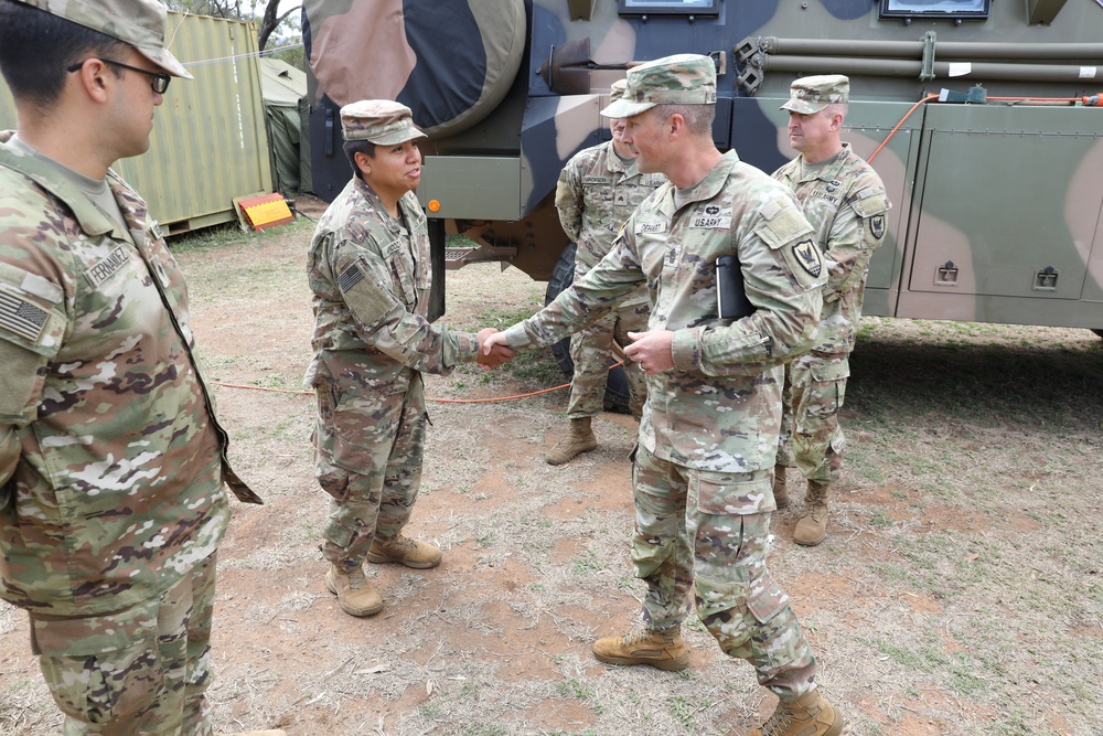 Command Sgt. Maj. Jonathan Dehart of the 311th Signal Command congratulates soldier