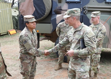 Command Sgt. Maj. Jonathan Dehart of the 311th Signal Command congratulates soldier