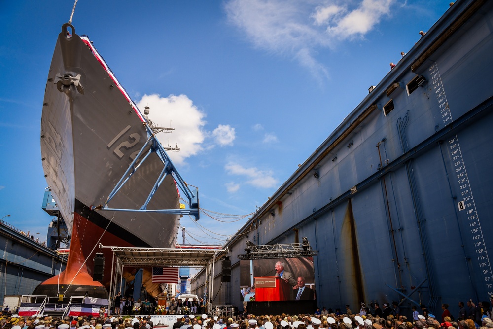 Secretary of the Navy Carlos Del Toro delivers remarks during the christening ceremony of USS Harvey C. Barnum Jr. (DDG 124)