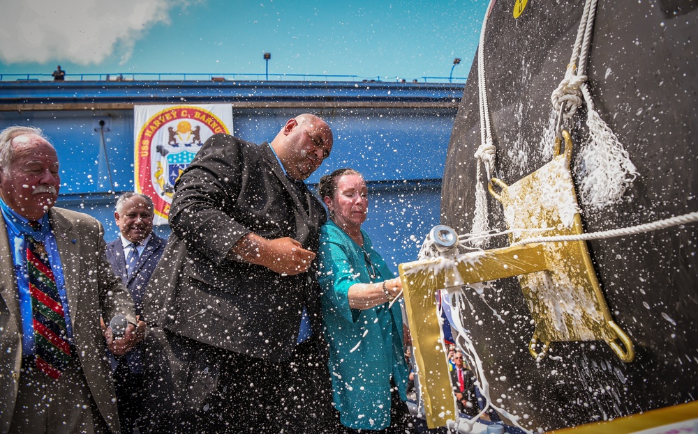 Secretary of the Navy Carlos Del Toro delivers remarks during the christening ceremony of USS Harvey C. Barnum (DDG 124)