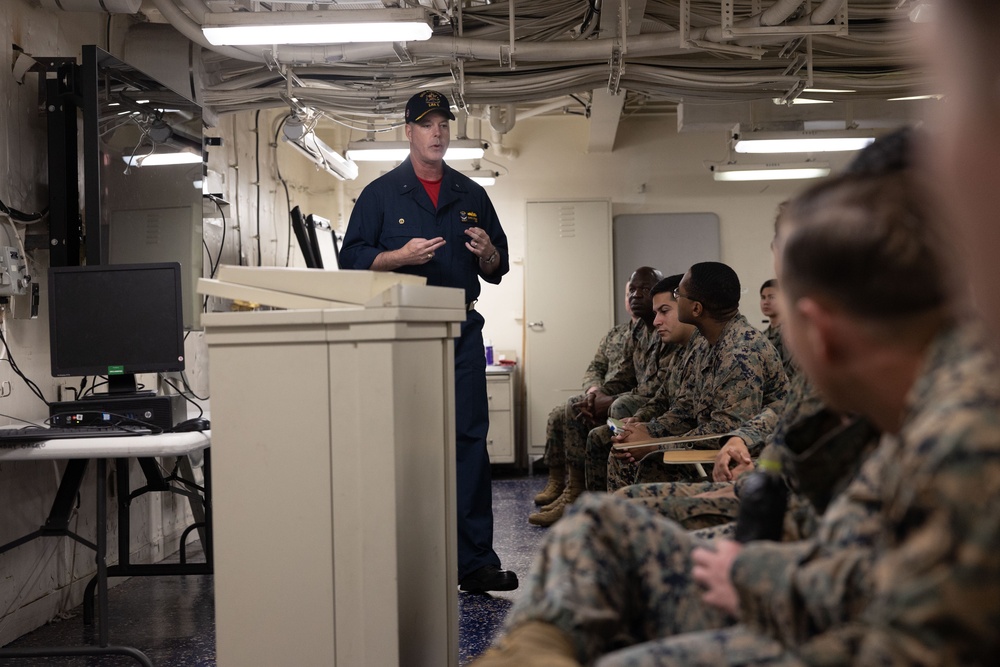 Rear Admiral Stone briefs SNCOs aboard USS America