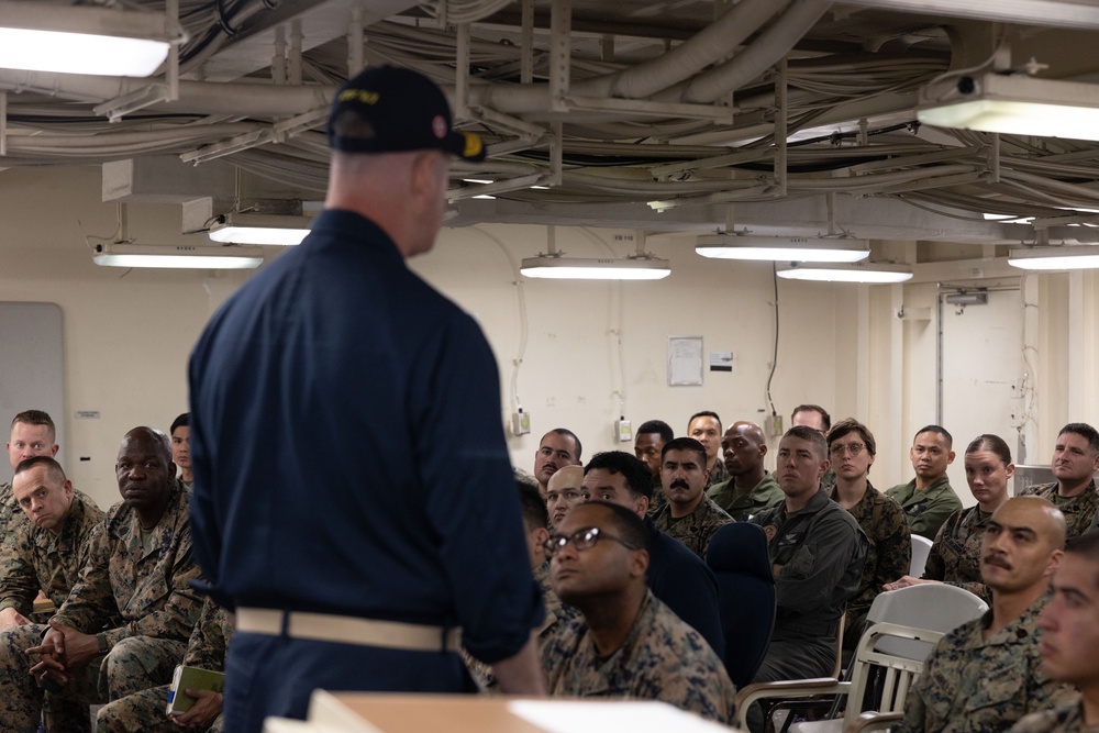 Rear Admiral Stone briefs SNCOs aboard USS America