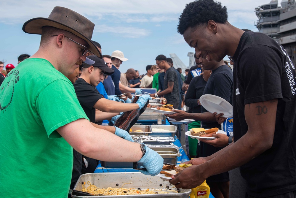 USS Ronald Reagan (CVN 76) holds a steel beach picnic during 20th anniversary of ship’s commissioning