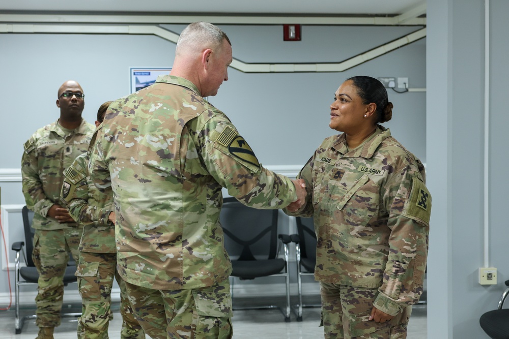 1st TSC commanding general presents commander's coins