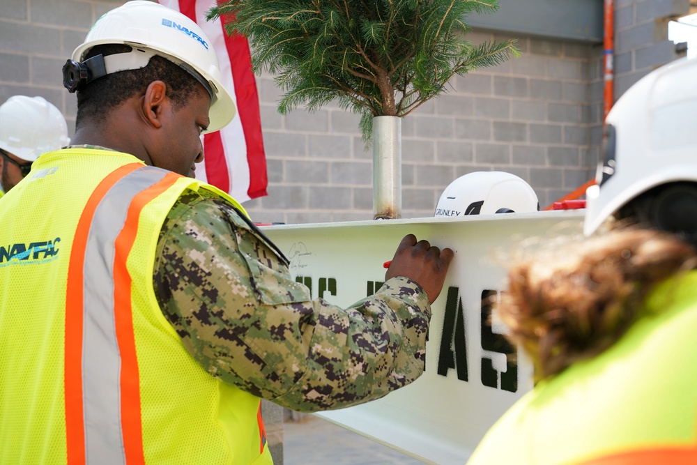 Capt. Atiim Senthill, NAVFAC Washington operations officer, signs steel beam at JADOC Phase Two construction site