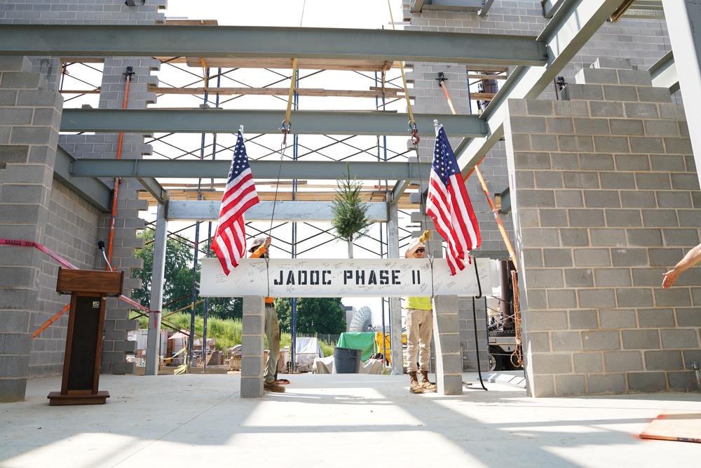 The final steel beam of the JADOC Phase Two construction project