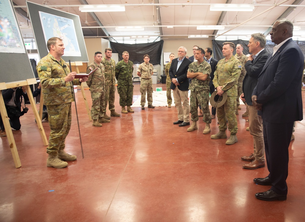 Chief of Staff Headquarters 1st (Australian) Division, Colonel Gavin Ware, briefs Secretary of Defense Lloyd J. Austin III