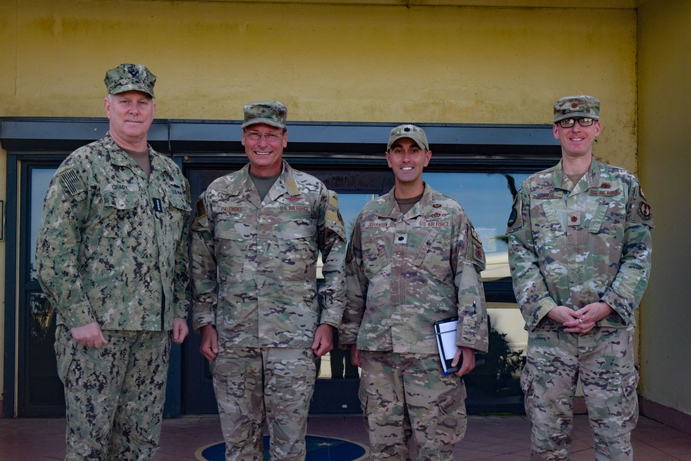 Adm. Christopher Grady poses with members of the 36th Wing.