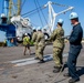 Sailors onload the aircraft crash and salvage crane onto the flight deck of Abraham Lincoln