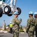 Sailors onload the aircraft crash and salvage crane onto the flight deck of Abraham Lincoln