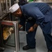 Sailors Prepare a Meal Aboard USS John Fin (DDG 113)