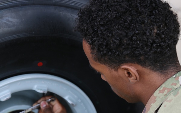 445th AMXS changes nose tires on C-17