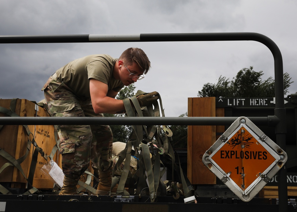 Airmen from the 87th and 721st Aerial Port Squadrons move explosive cargo at Ramstein Air Base, Germany