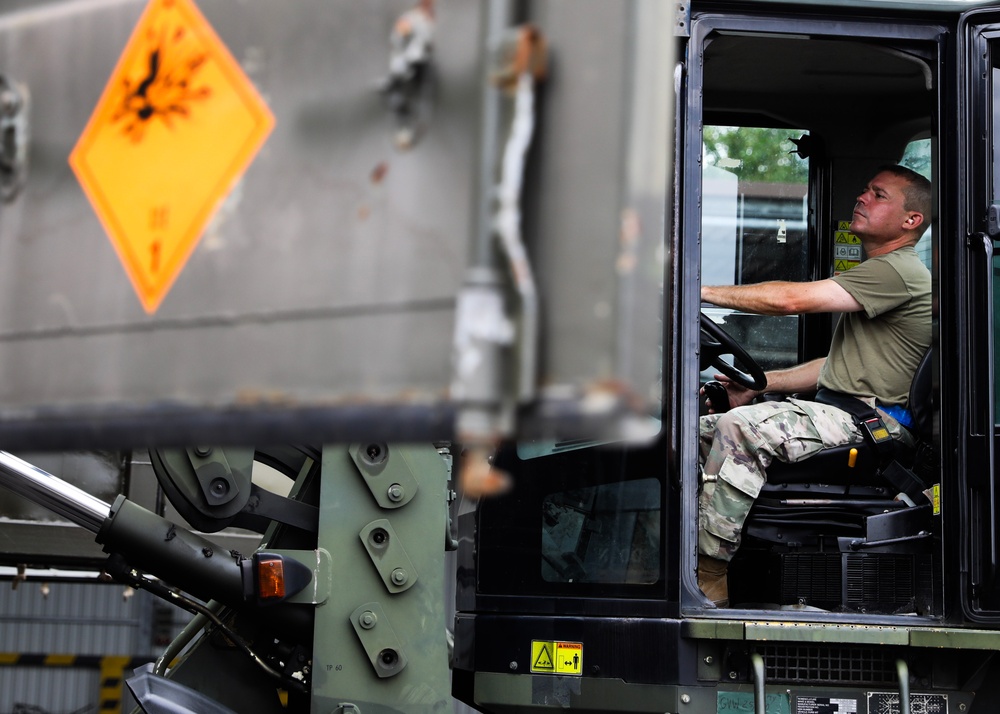 Airmen from the 87th and 721st Aerial Port Squadrons move explosive cargo at Ramstein Air Base, Germany