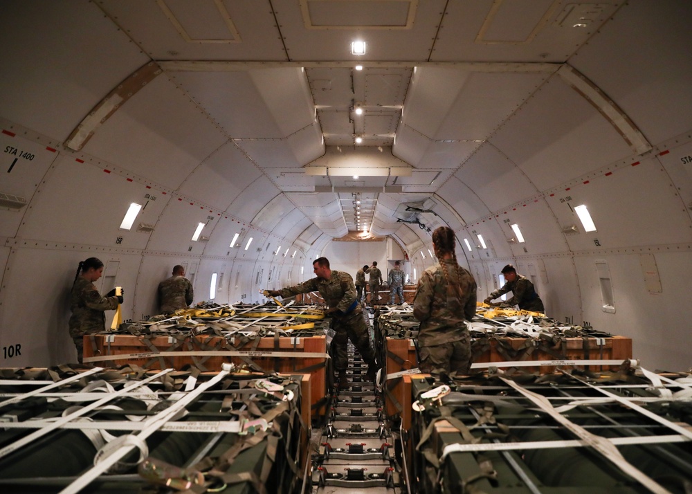 Airmen from the 87th and 721st Aerial Port Squadrons move explosive cargo at Ramstein Air Base, Germany