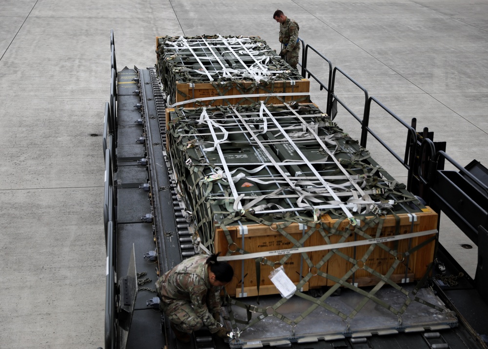 Airmen from the 87th and 721st Aerial Port Squadrons move explosive cargo at Ramstein Air Base, Germany