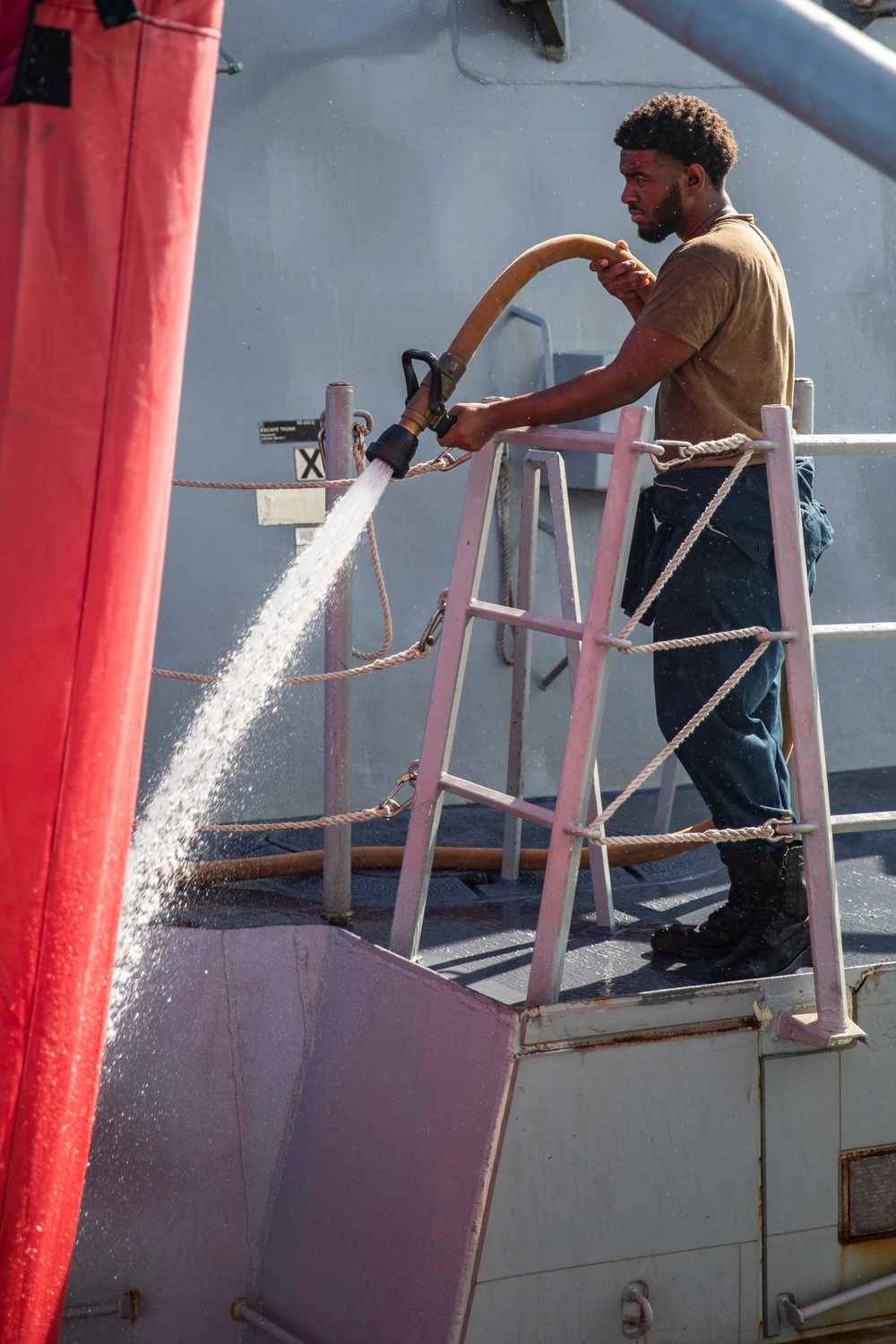 Ralph Johnson Sailors conduct a fresh water washdown in the South China Sea.