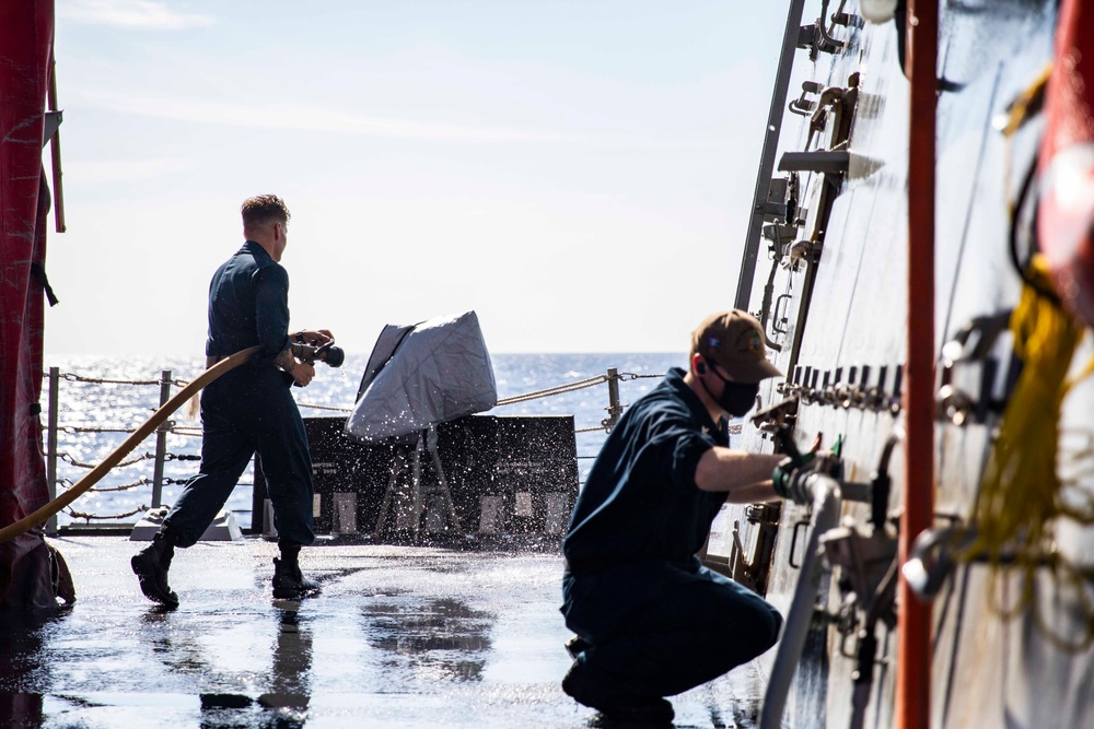 Ralph Johnson Sailors conduct a fresh water washdown in the South China Sea.