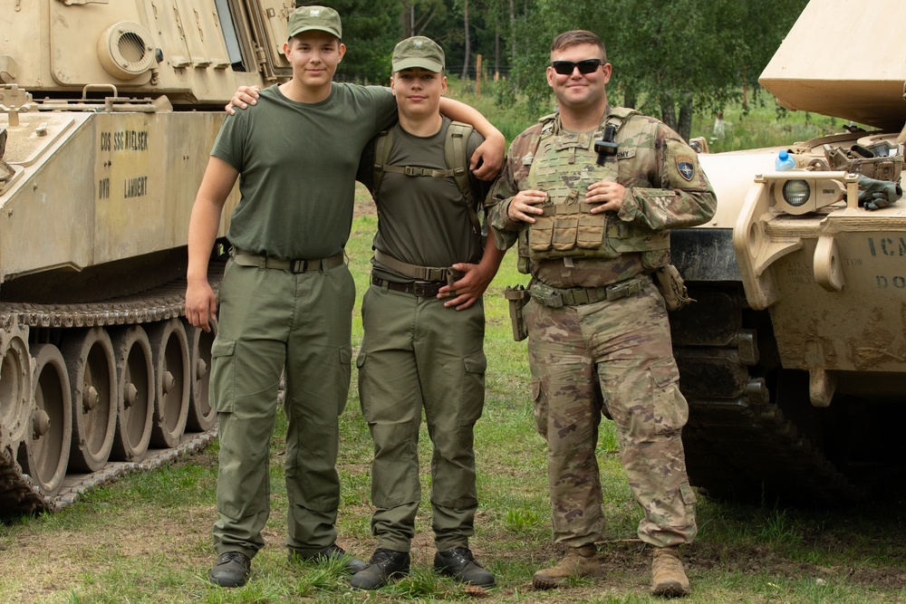 Task Force Ivy, NATO soldiers familiarize junior cadets with military equipment during Baltic Guard