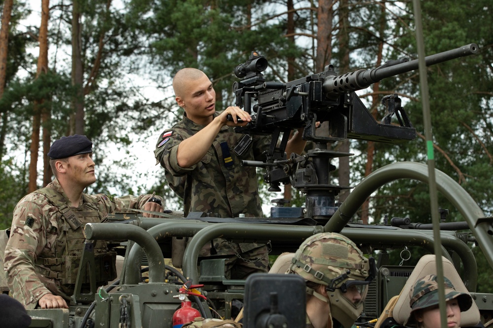 Task Force Ivy, NATO soldiers familiarize junior cadets with military equipment during Baltic Guard