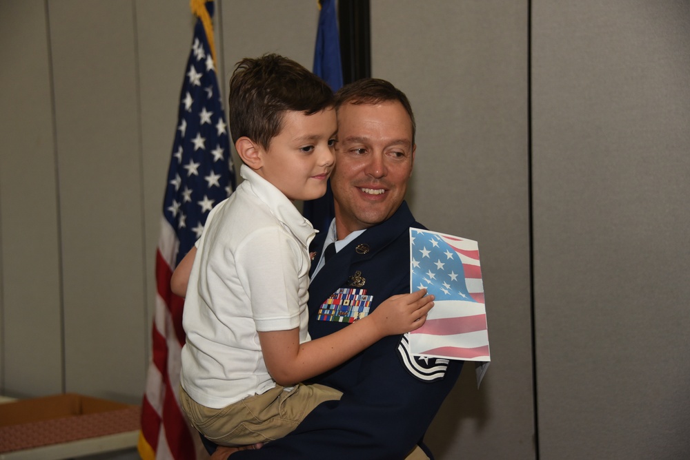 Chief Master Sergeant Zachary Terry hugs his son